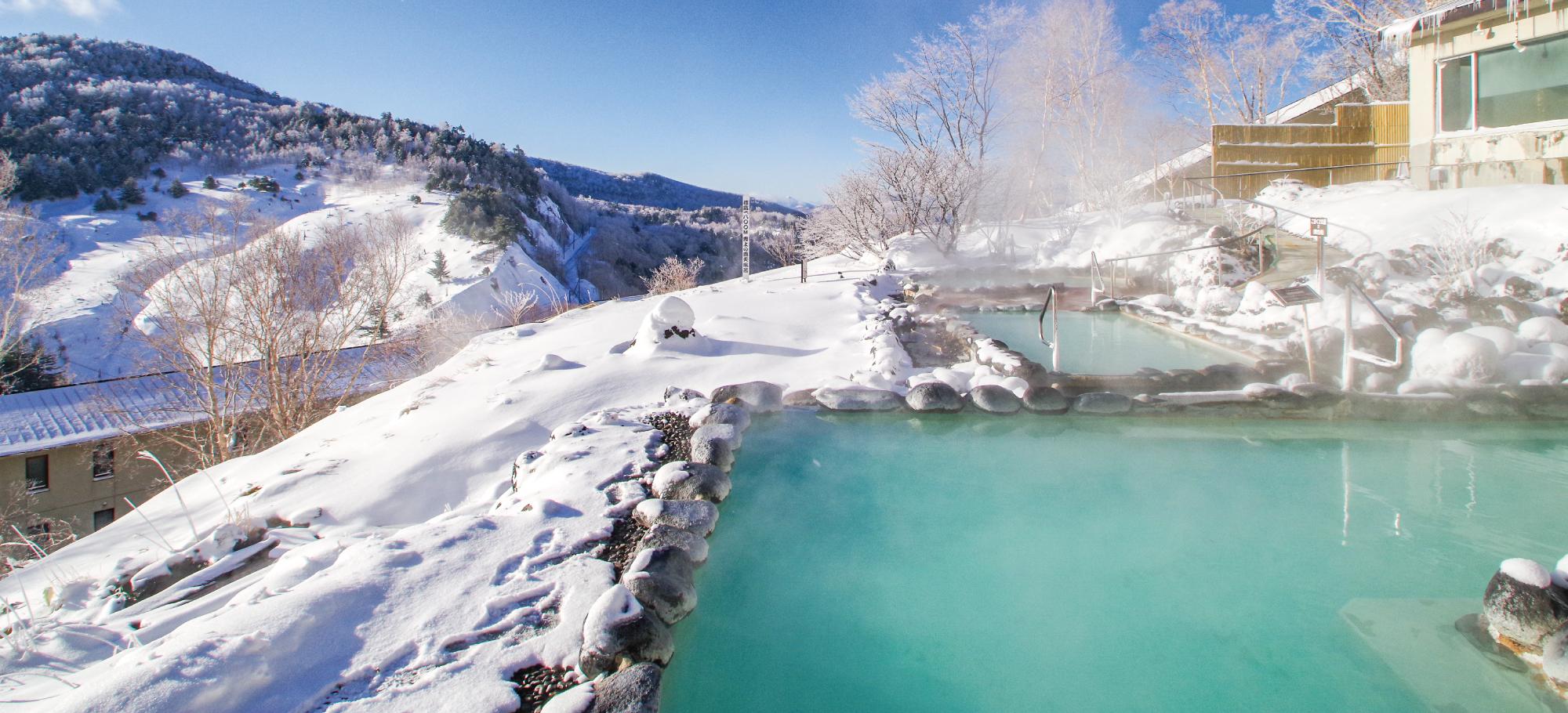 万座プリンスホテル — 群馬県嬬恋村 · 雪景色の中に湯けむりが上がる乳白色の露天風呂「こまくさの湯」